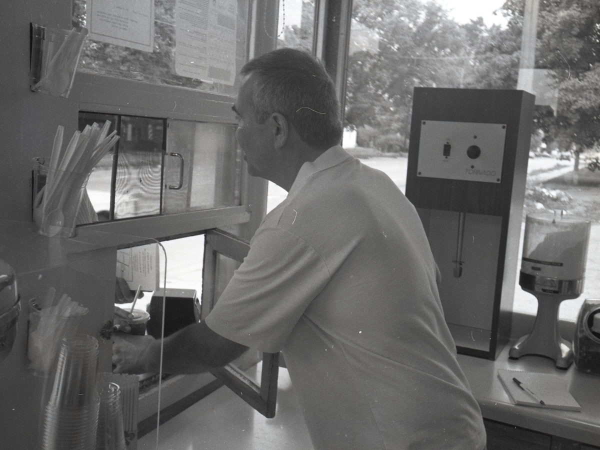 An Ollie's worker serving at the walk-up window in 1994
